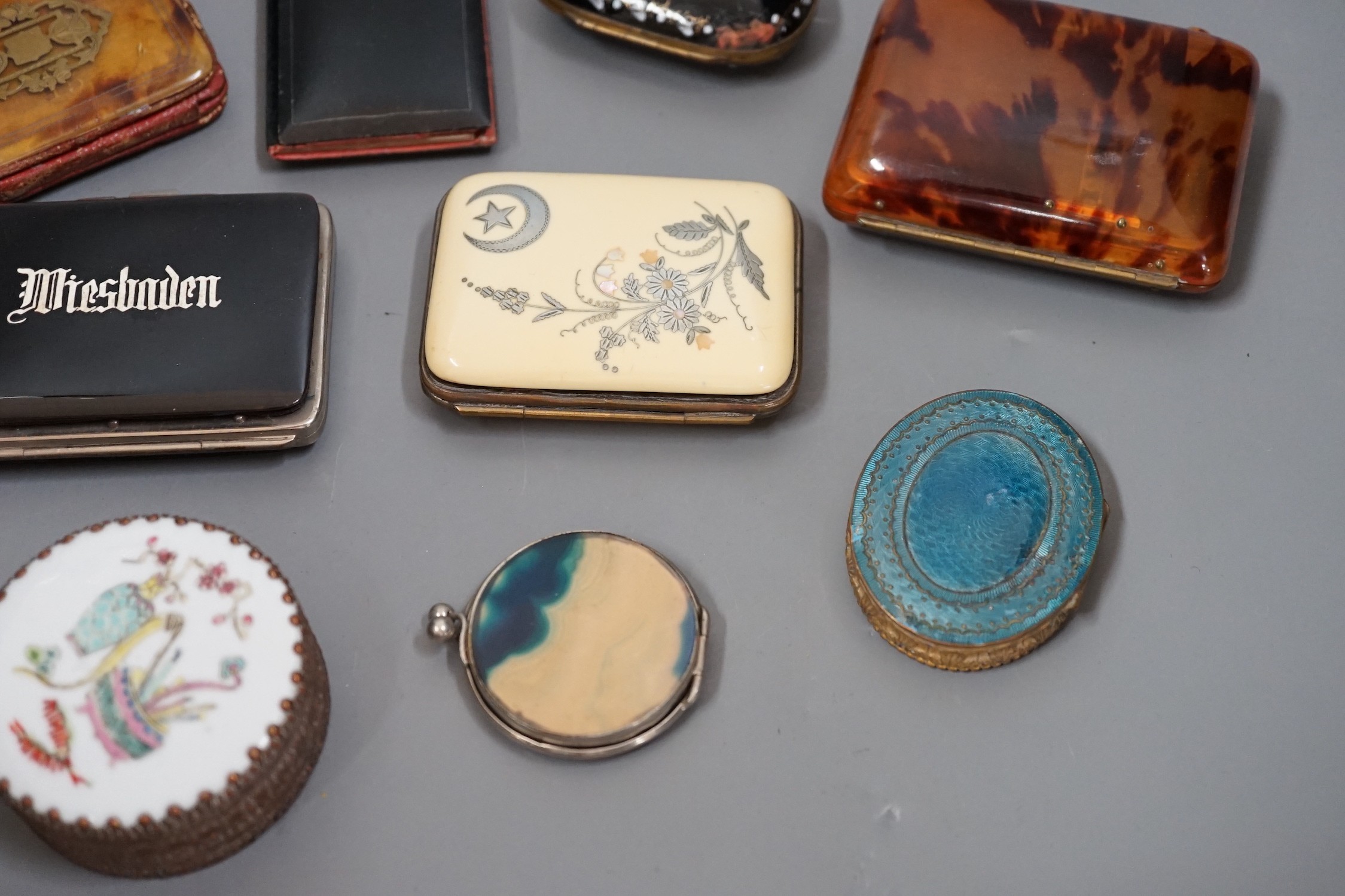 A mixed collection of enamel, tortoiseshell and other purses, a Chinese porcelain box and enamel topped box